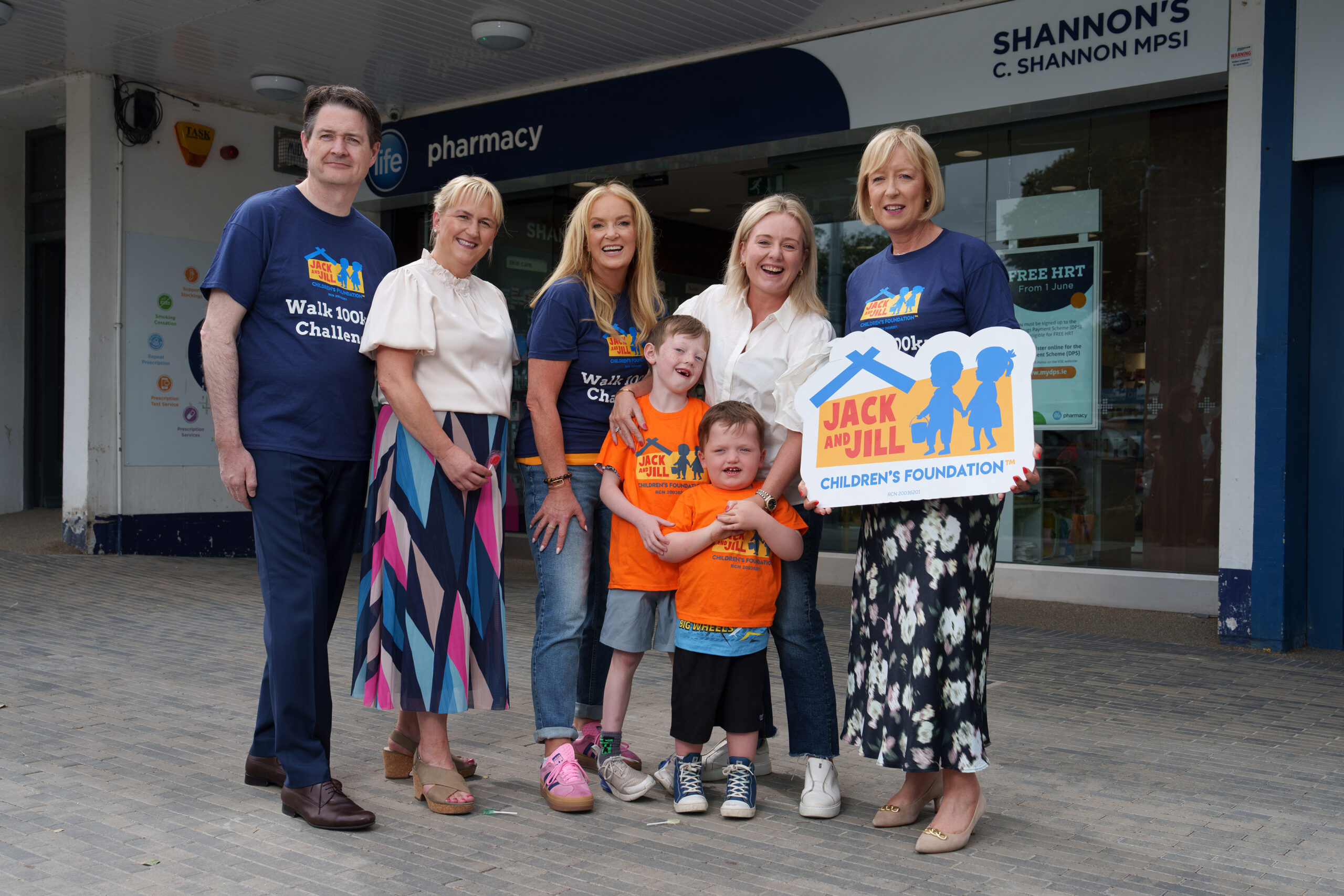 NO FEE PIC
PIC JULIEN BEHAL PHOTOGRAPHY 
Dr. Ciara Kelly steps up to joins forces with Life Pharmacy and the Jack and Jill Children’s Foundation to launch the “Walk 100km in September” campaign at Shannon’s Life Pharmacy, Rathfarnham. Pictured are Criofan Shannon, pharmacist, Life Pharmacy; Louise Garry and her sons Ross (aged 3) and Brady (aged 7); Deirdre Walsh, CEO, Jack and Jill Children’s Foundation; and campaign ambassador Dr. Ciara Kelly. The nationwide fundraising campaign officially launches this month, with Life Pharmacy teams across the country leading the charge with the goal of raising €100,000 to fund 5,556 hours of in-home nursing care for families with children, up to the age of six, with severe learning disabilities often associated with complex medical needs.